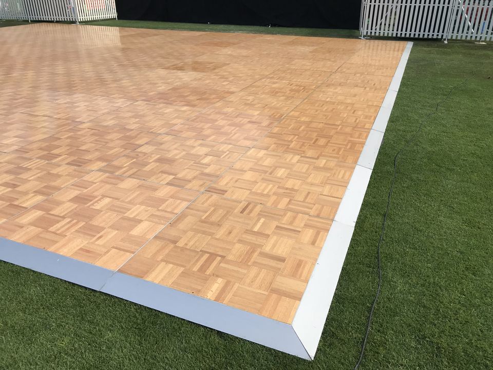 Timber parquetry dance floor laid on a lawn