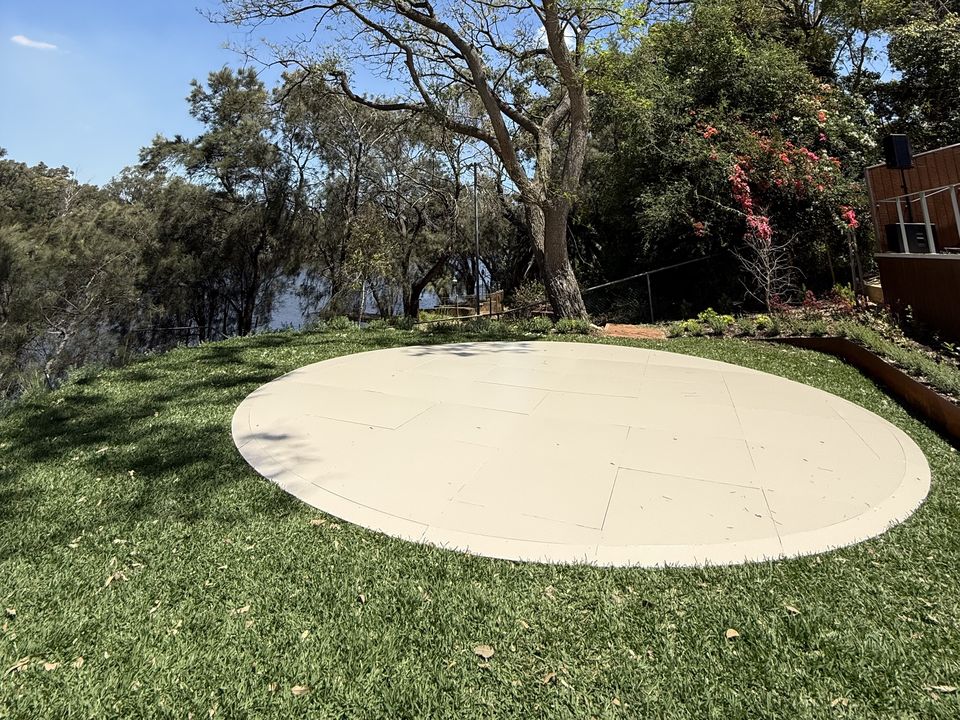 Round cream dance floor on a lawn under a gum tree