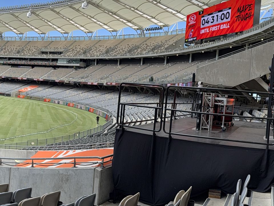 Black-skirted railed platform in the stands of a stadium