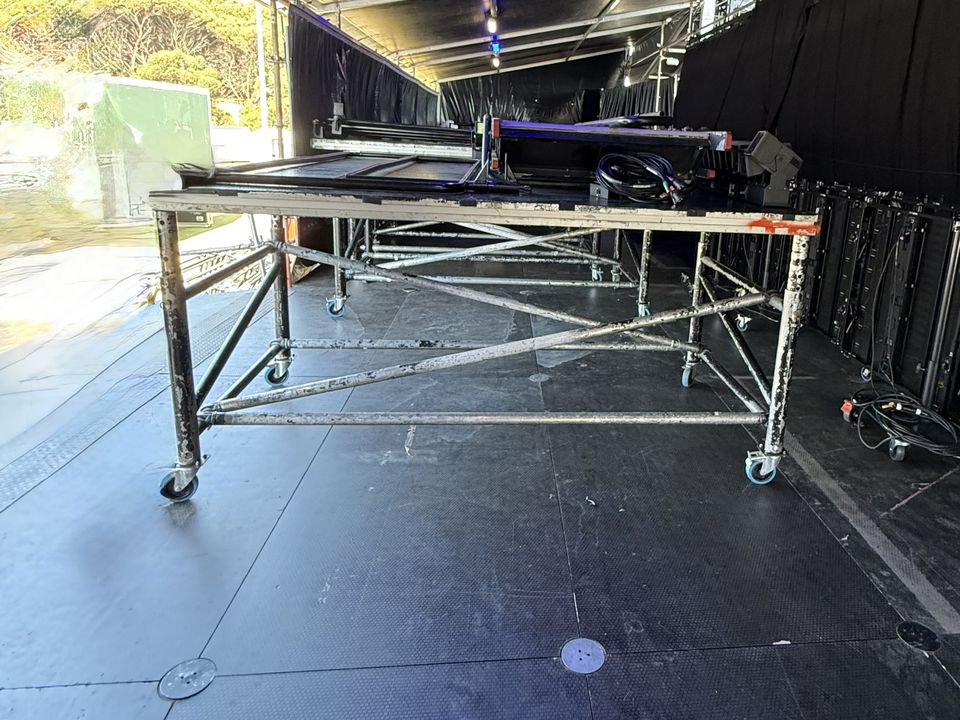 Rolling stage riser on wheels on the deck of a covered festival stage