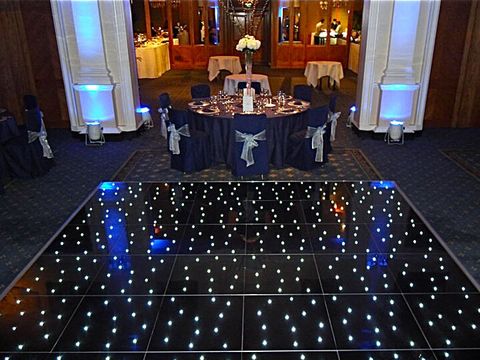 Black LED Starlight dance floor with white twinkling lights in a reception room